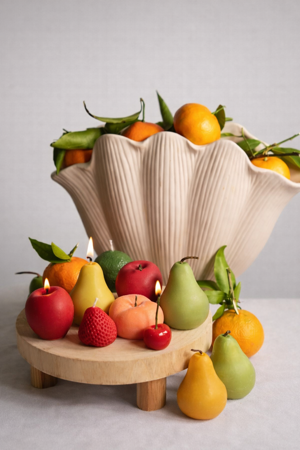 Handmade fruit-shaped candles in soy wax. One-of-a-kind textures, warm glow, and timeless shelf appeal for aesthetic spaces.