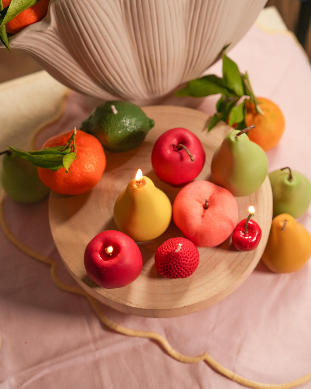 Handmade fruit-shaped candles in soy wax. One-of-a-kind textures, warm glow, and timeless shelf appeal for aesthetic spaces.
